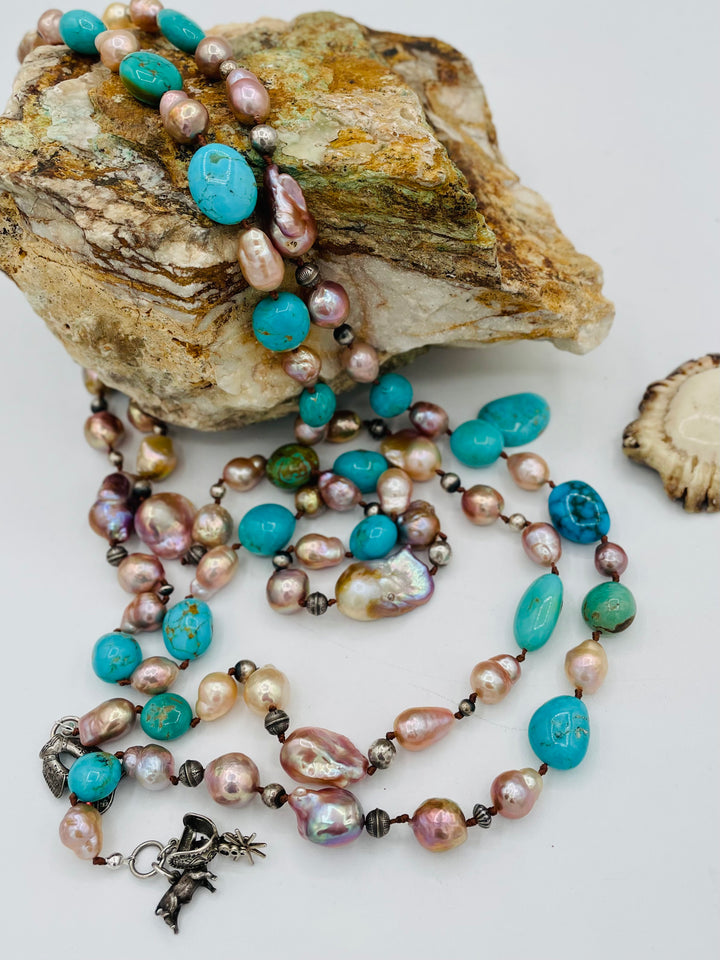 Silk knotted lariat necklace featuring baroque natural luster pearls, Kingman turquoise nuggets, and sterling silver beads. Available only from Rockstar Cowgirl online or in store in Cody, Wyoming.