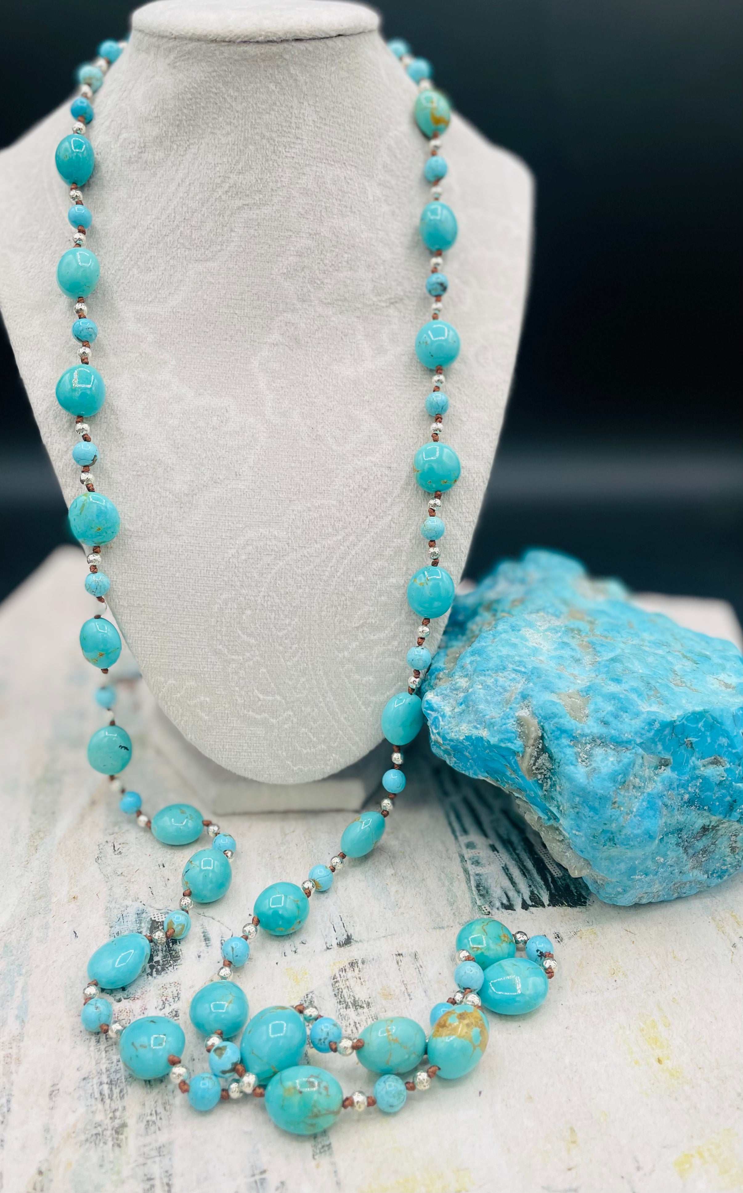 Long silk knotted necklace featuring Kingman turquoise nuggets and rounds with gold matrix, and hammered sterling silver beads. Available only from Rockstar Cowgirl online or in store in Cody, Wyoming.