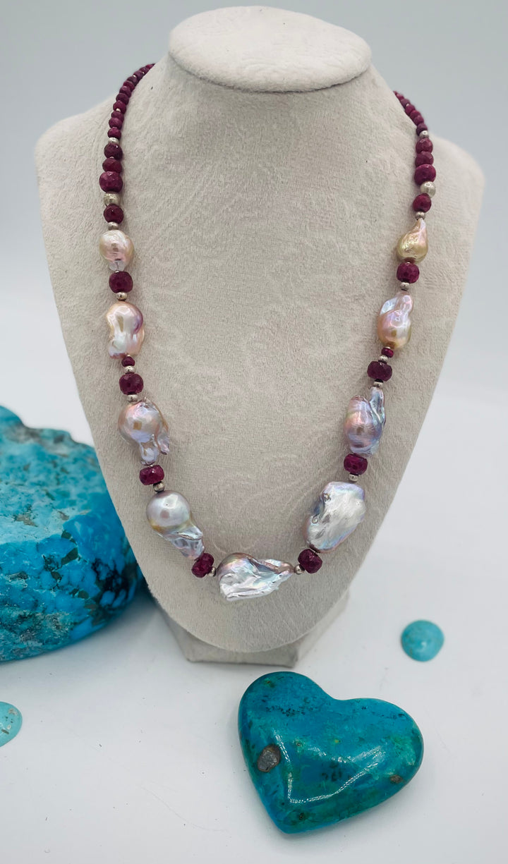 Adjustable beaded hatband featuring flameball natural luster baroque pearls, ruby, sterling silver beads, African silver, and finished with deer lace in the back. Available only from Rockstar Cowgirl online or in store in Cody, Wyoming.