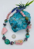 Chunky necklace featuring pink Peruvian opal nuggets, Kingman turquoise, cape amethyst, amazonite, and sterling silver Navajo pearl beads. U.S. quarter for size reference. Available only from Rockstar Cowgirl online or in store in Cody, Wyoming.