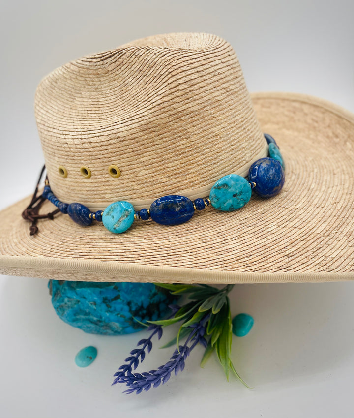 Adjustable beaded hatband featuring lapis nuggets, Kingman turquoise nuggets, African brass details, and finished with deer lace in the back. Available only from Rockstar Cowgirl online or in store in Cody, Wyoming.