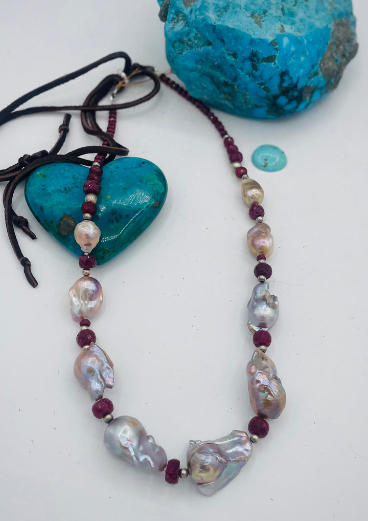 Adjustable beaded hatband featuring flameball natural luster baroque pearls, ruby, sterling silver beads, African silver, and finished with deer lace in the back. Available only from Rockstar Cowgirl online or in store in Cody, Wyoming.