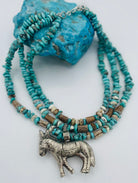 3 strand necklace featuring Campitos turquoise, chrysoprase, and deer antler beads with a donkey pendent. Available only from Rockstar Cowgirl online or in store in Cody, Wyoming.