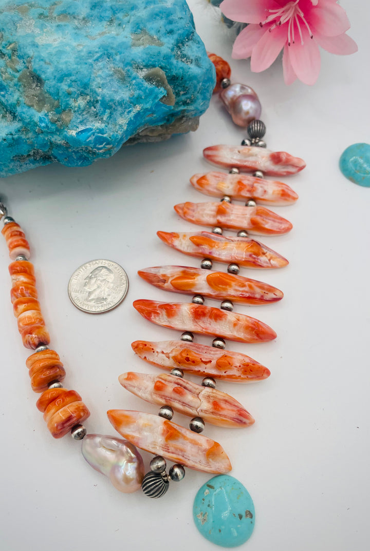 Adjustable beaded hatband featuring spiney oyster, natural luster flameball pearls, sterling silver beads, and finished with deer lace in the back. U.S. quarter for size reference. Available only from Rockstar Cowgirl online or in store in Cody, Wyoming.