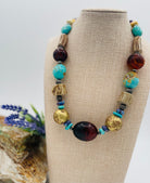 Chunky necklace featuring Baltic amber, Kingman turquoise, African bronze beads, large deer antler beads, and sterling silver Navajo pearl beads. Available only from Rockstar Cowgirl online or in store in Cody, Wyoming.