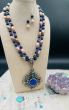 Double strand necklace featuring lapis, purple mystic quartz, natural luster baroque pearls, sterling silver round beads, and a Bali silver pendent with lapis, pink amethyst, and green amethyst. Includes matching earrings. Available only from Rockstar Cowgirl online or in store in Cody, Wyoming.