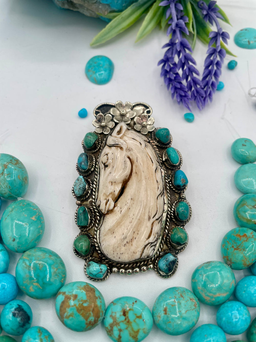 Bead box featuring Kingman turquoise nuggets in 3 colors, sodalite calcite, sodalite, denim lapis, Hubei turquoise, and carved bone horse and turquoise pendent. U.S. quarter for size reference. Available only from Rockstar Cowgirl online or in store in Cody, Wyoming.