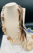 Baroque natural luster pearls, Edison pearls, knobby deer antler beads, moonstone, and sterling silver hatband finished with feathers, deer lace and slide bead. Available only from Rockstar Cowgirl online or in store in Cody, Wyoming.