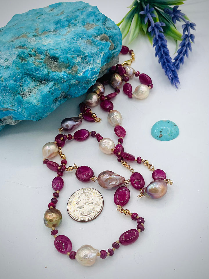 Silk knotted treasure necklace featuring rubies and natural luster Edison pearls. U.S. quarter for size reference. Available only from Rockstar Cowgirl online or in store in Cody, Wyoming.