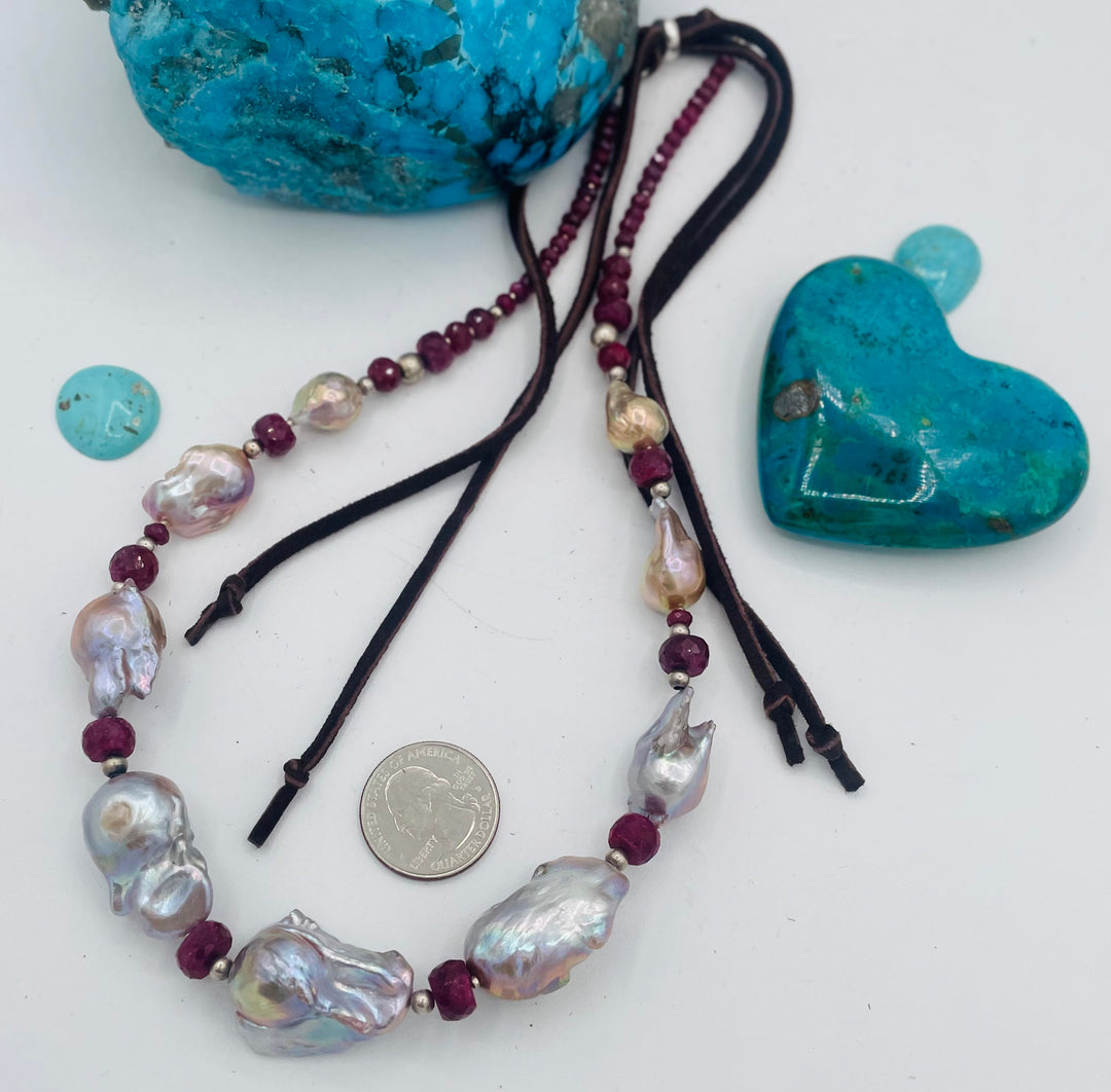 Adjustable beaded hatband featuring flameball natural luster baroque pearls, ruby, sterling silver beads, African silver, and finished with deer lace in the back. U.S. quarter for size reference. Available only from Rockstar Cowgirl online or in store in Cody, Wyoming.