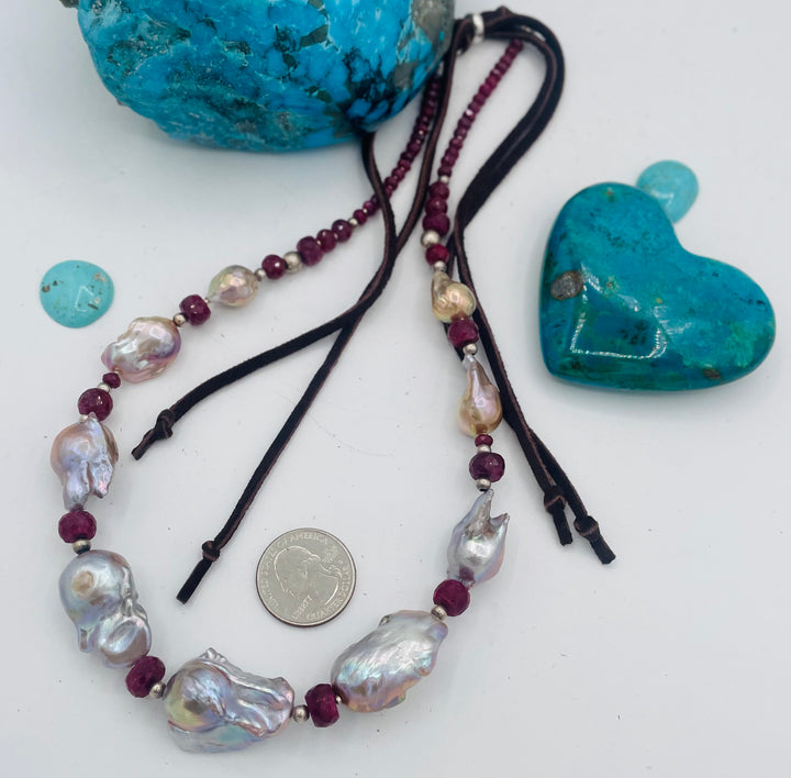 Adjustable beaded hatband featuring flameball natural luster baroque pearls, ruby, sterling silver beads, African silver, and finished with deer lace in the back. U.S. quarter for size reference. Available only from Rockstar Cowgirl online or in store in Cody, Wyoming.