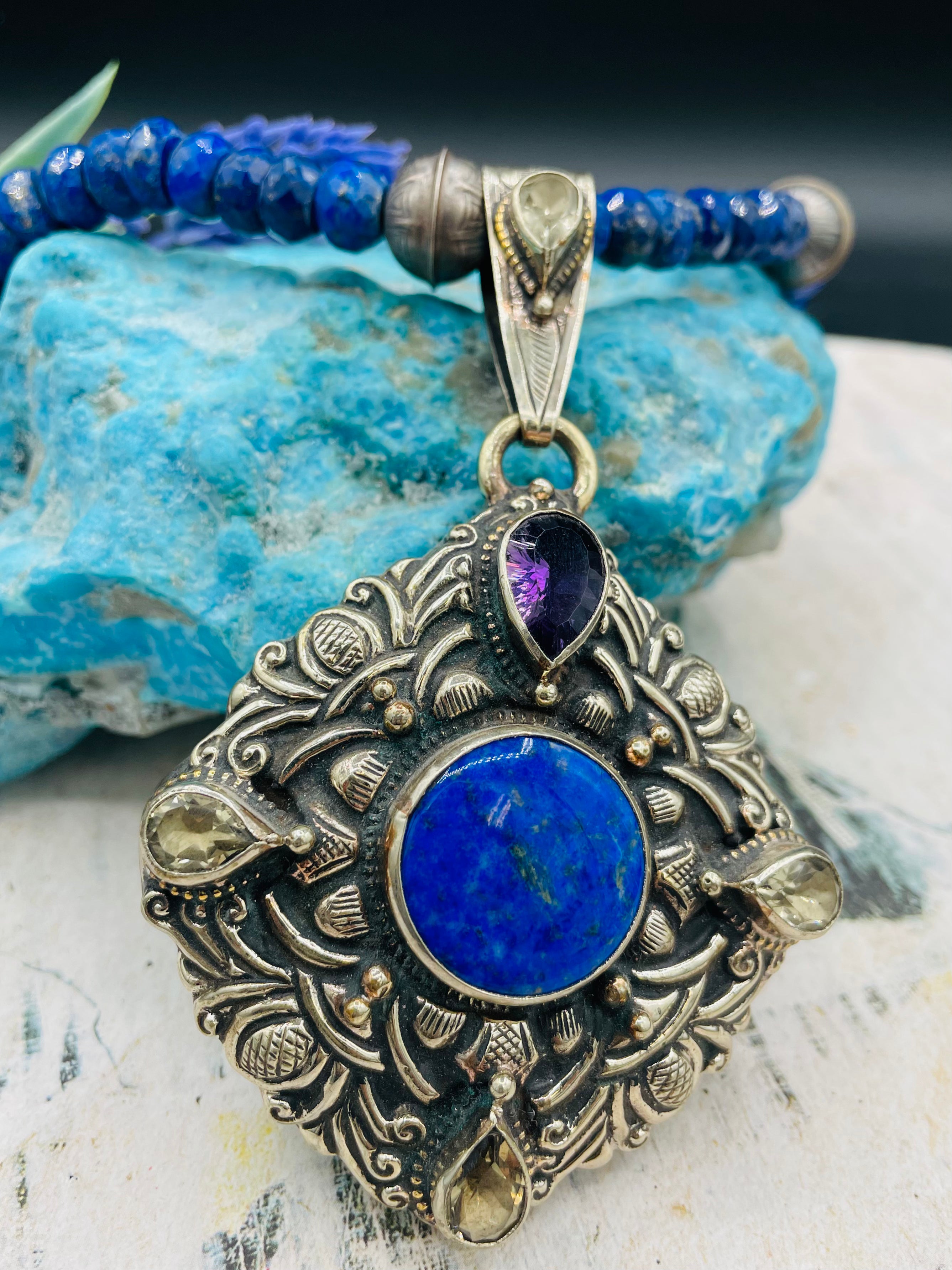 Lapis necklace with stamped sterling silver beads and a Bali silver pendent featuring lapis, lemon quartz, and amethyst. Available only from Rockstar Cowgirl online or in store in  
Cody, Wyoming.  