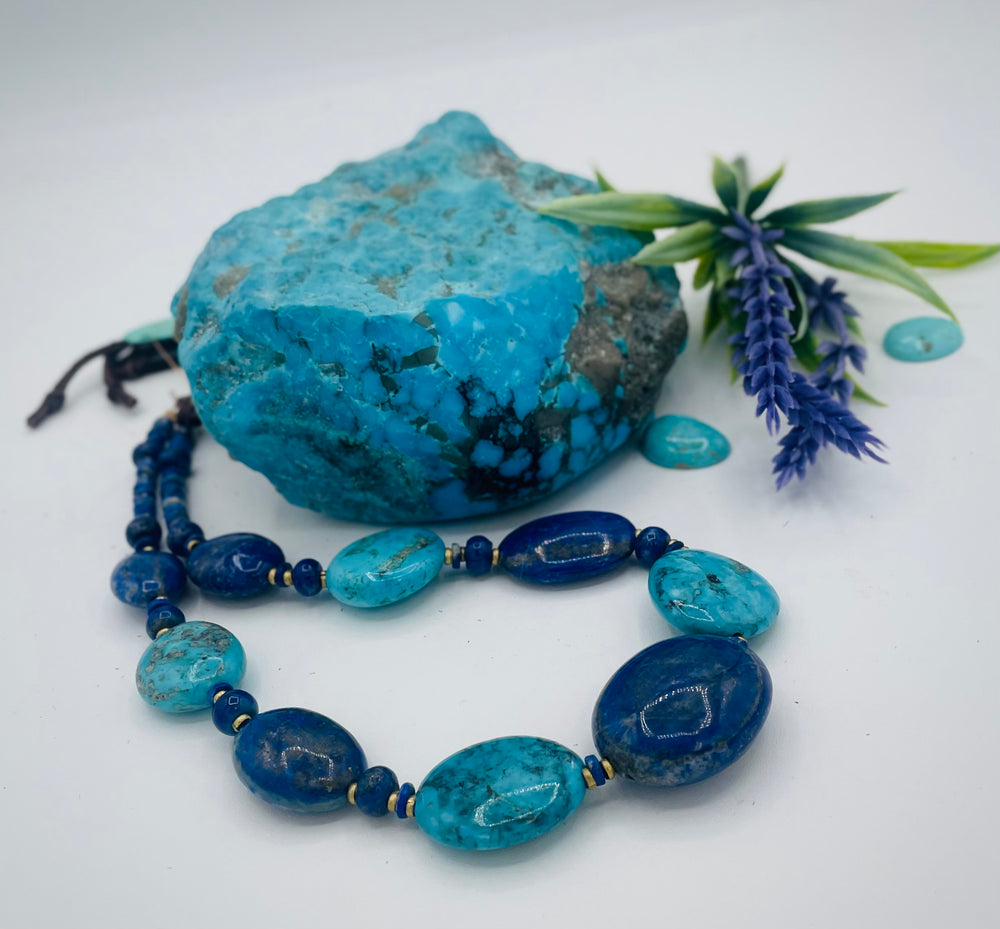 Adjustable beaded hatband featuring lapis nuggets, Kingman turquoise nuggets, African brass details, and finished with deer lace in the back. Available only from Rockstar Cowgirl online or in store in Cody, Wyoming.