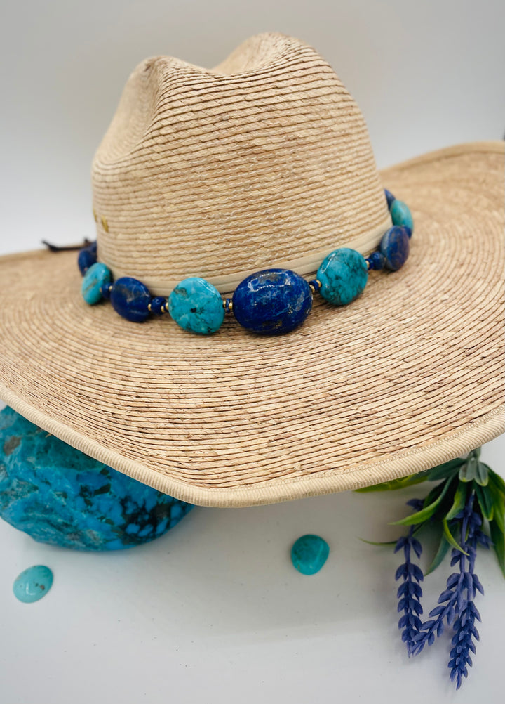 Adjustable beaded hatband featuring lapis nuggets, Kingman turquoise nuggets, African brass details, and finished with deer lace in the back. Available only from Rockstar Cowgirl online or in store in Cody, Wyoming.