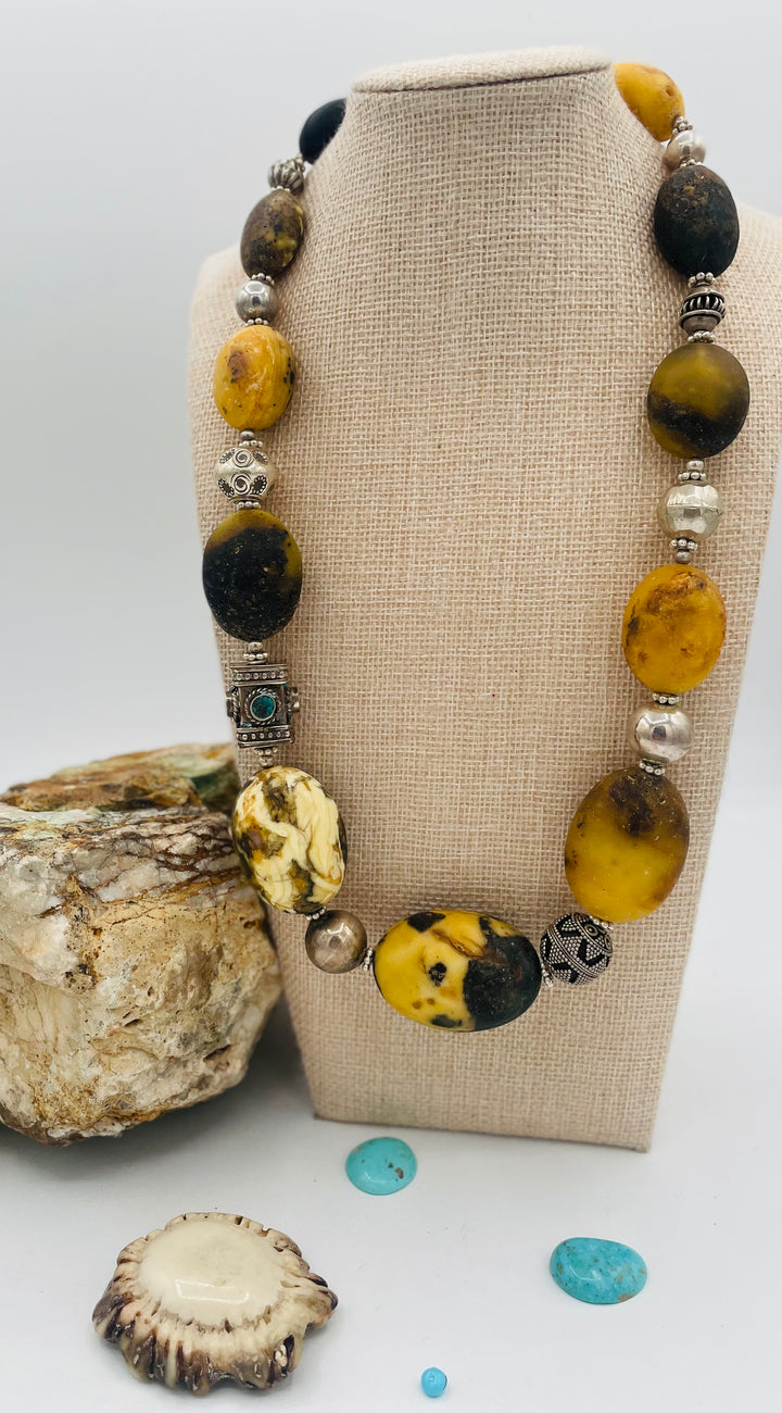 Chunky beaded necklace featuring Baltic amber, repousse beads with turquoise inlay, and sterling silver beads. Available only from Rockstar Cowgirl online or in store in Cody, Wyoming.
