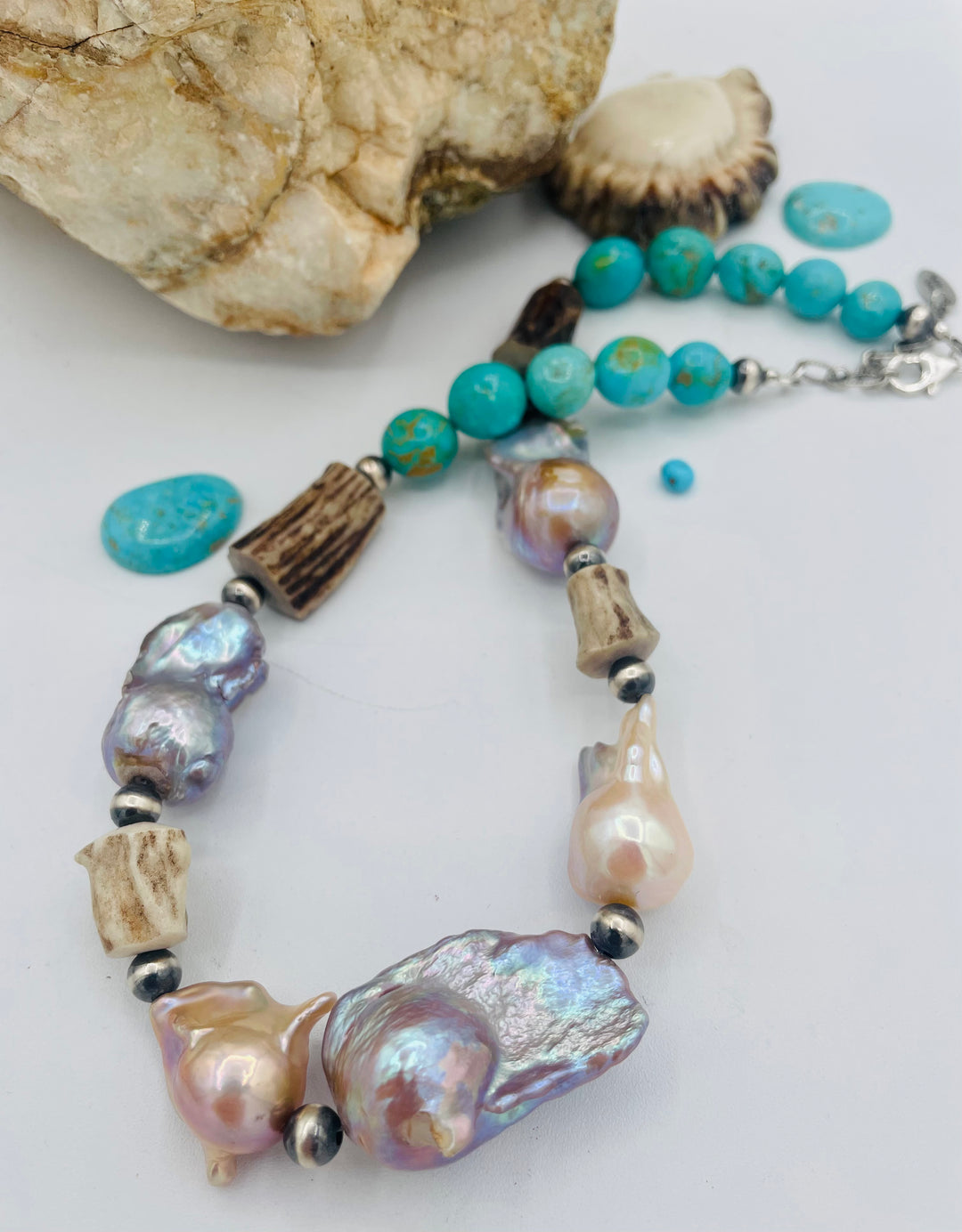 Beaded necklace featuring Flame ball natural luster baroque pearls, deer antler, Kingman turquoise nuggets, and sterling silver beads. Available only from Rockstar Cowgirl online or in store in Cody, Wyoming.