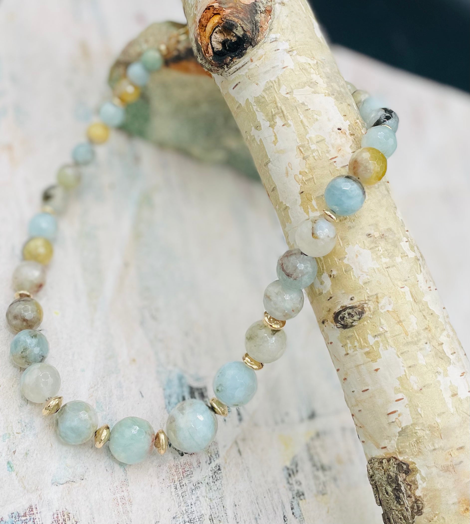 Aquamarine graduated round beaded necklace with hammered 14k gold beads sprinkled throughout. Available only from Rockstar Cowgirl online or in store in Cody, Wyoming.