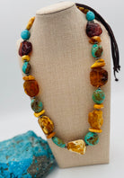 Adjustable beaded hatband featuring Kingman turquoise, Baltic amber, and sterling silver Navajo pearl beads and finished with deer leather and a silicone slide bead. Available only from Rockstar Cowgirl online or in store in Cody, Wyoming.