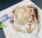 Baroque natural luster pearls, Edison pearls, knobby deer antler beads, moonstone, and sterling silver hatband finished with feathers, deer lace and slide bead. Available only from Rockstar Cowgirl online or in store in Cody, Wyoming.