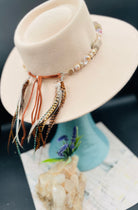 Baroque natural luster pearls, Edison pearls, knobby deer antler beads, moonstone, and sterling silver hatband finished with feathers, deer lace and slide bead. Available only from Rockstar Cowgirl online or in store in Cody, Wyoming.