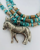 3 strand necklace featuring Campitos turquoise, chrysoprase, and deer antler beads with a donkey pendent. Available only from Rockstar Cowgirl online or in store in Cody, Wyoming.