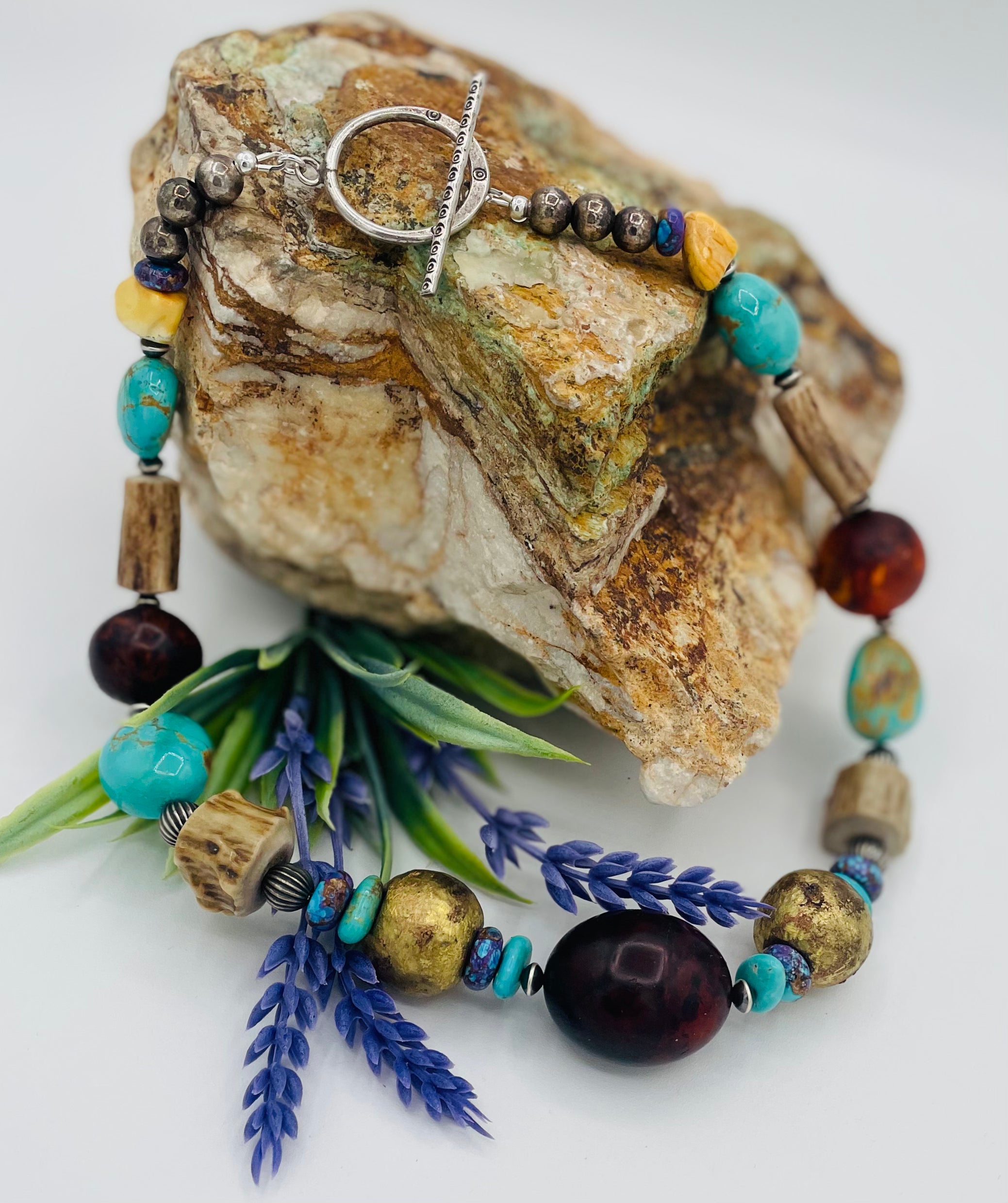 Chunky necklace featuring Baltic amber, Kingman turquoise, African bronze beads, large deer antler beads, and sterling silver Navajo pearl beads. Available only from Rockstar Cowgirl online or in store in Cody, Wyoming.
