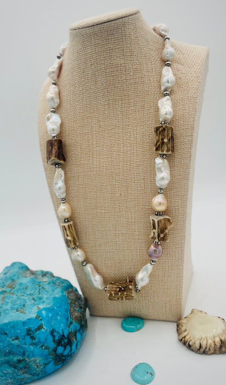 Adjustable beaded hattband featuring white flameball baroque pearls, textured deer antler, sterling silver beads, and finished with deer lace in the back. Available only from Rockstar Cowgirl online or in store in Cody, Wyoming.