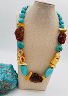 Adjustable beaded hatband featuring Kingman turquoise, Baltic amber, and sterling silver Navajo pearl beads and finished with deer leather and a silicone slide bead. Available only from Rockstar Cowgirl online or in store in Cody, Wyoming.