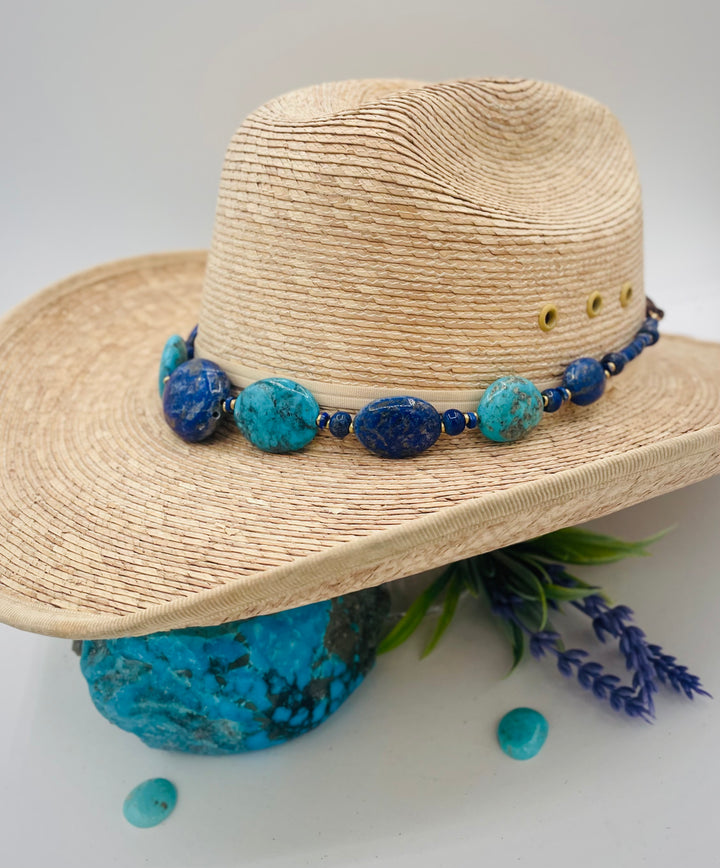 Adjustable beaded hatband featuring lapis nuggets, Kingman turquoise nuggets, African brass details, and finished with deer lace in the back. Available only from Rockstar Cowgirl online or in store in Cody, Wyoming.