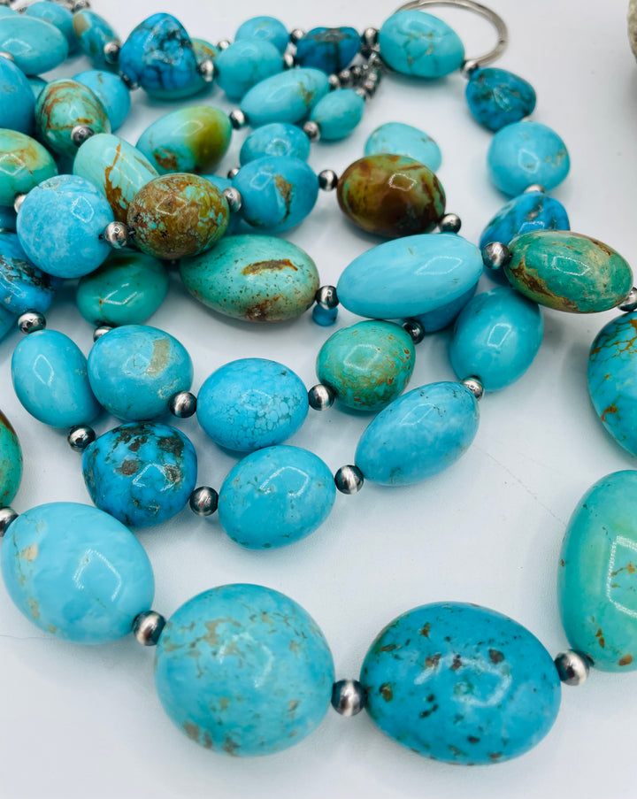 3 strand beaded necklace featuring Kingman turquoise in blues and greens with sterling silver Navajo pearl beads. Available only from Rockstar Cowgirl online or in store in Cody, Wyoming.