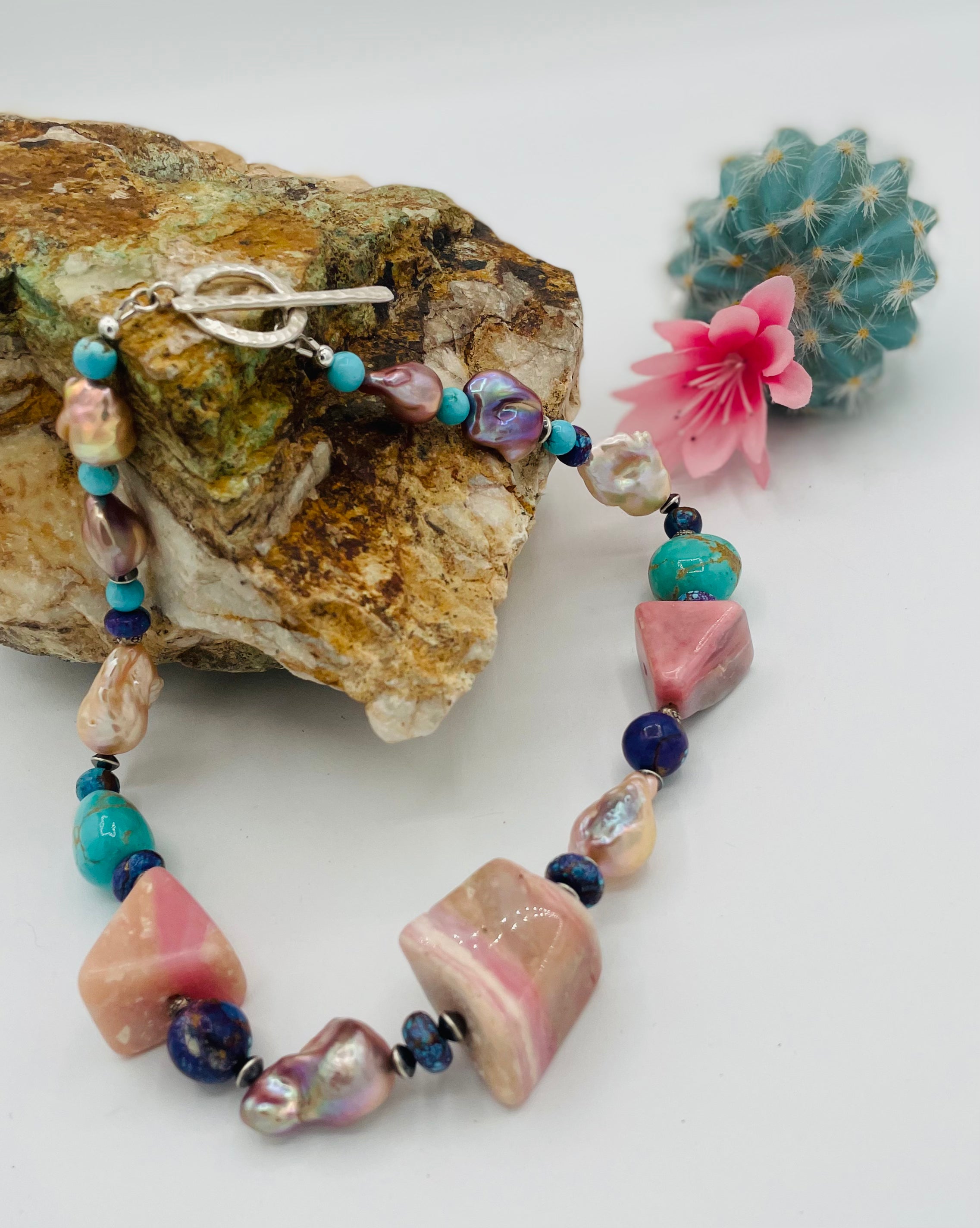 Chunky necklace featuring giant pink Peruvian opal nuggets, AAA grade natural luster baroque pearls, purple Mojave turquoise, and sterling silver Navajo pearl beads. Available only from Rockstar Cowgirl online or in store in Cody, Wyoming.
