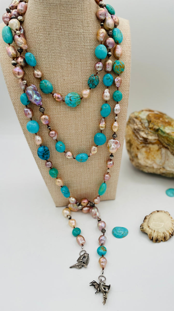 Silk knotted lariat necklace featuring baroque natural luster pearls, Kingman turquoise nuggets, and sterling silver beads. Available only from Rockstar Cowgirl online or in store in Cody, Wyoming.