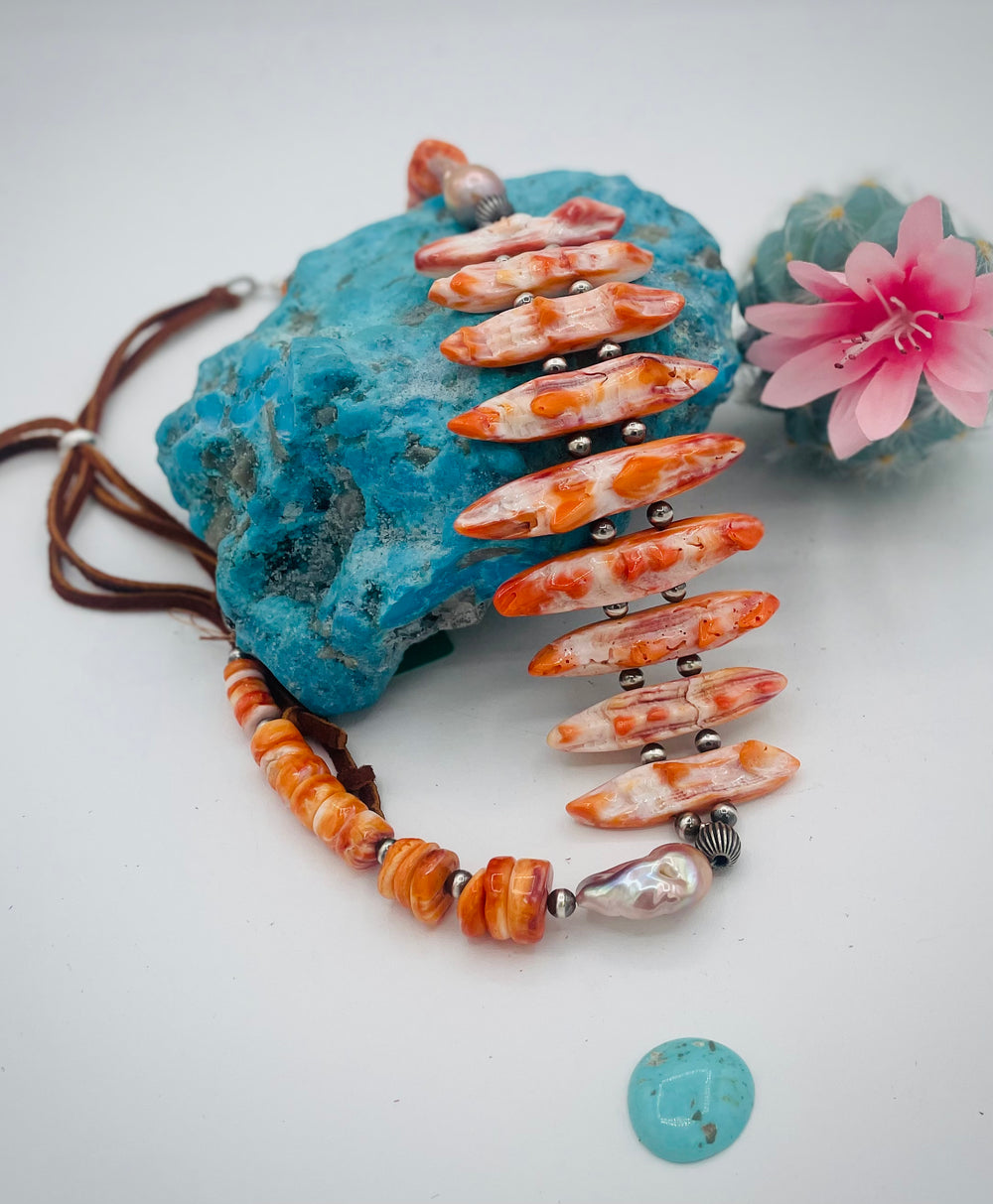 Adjustable beaded hatband featuring spiney oyster, natural luster flameball pearls, sterling silver beads, and finished with deer lace in the back. Available only from Rockstar Cowgirl online or in store in Cody, Wyoming.