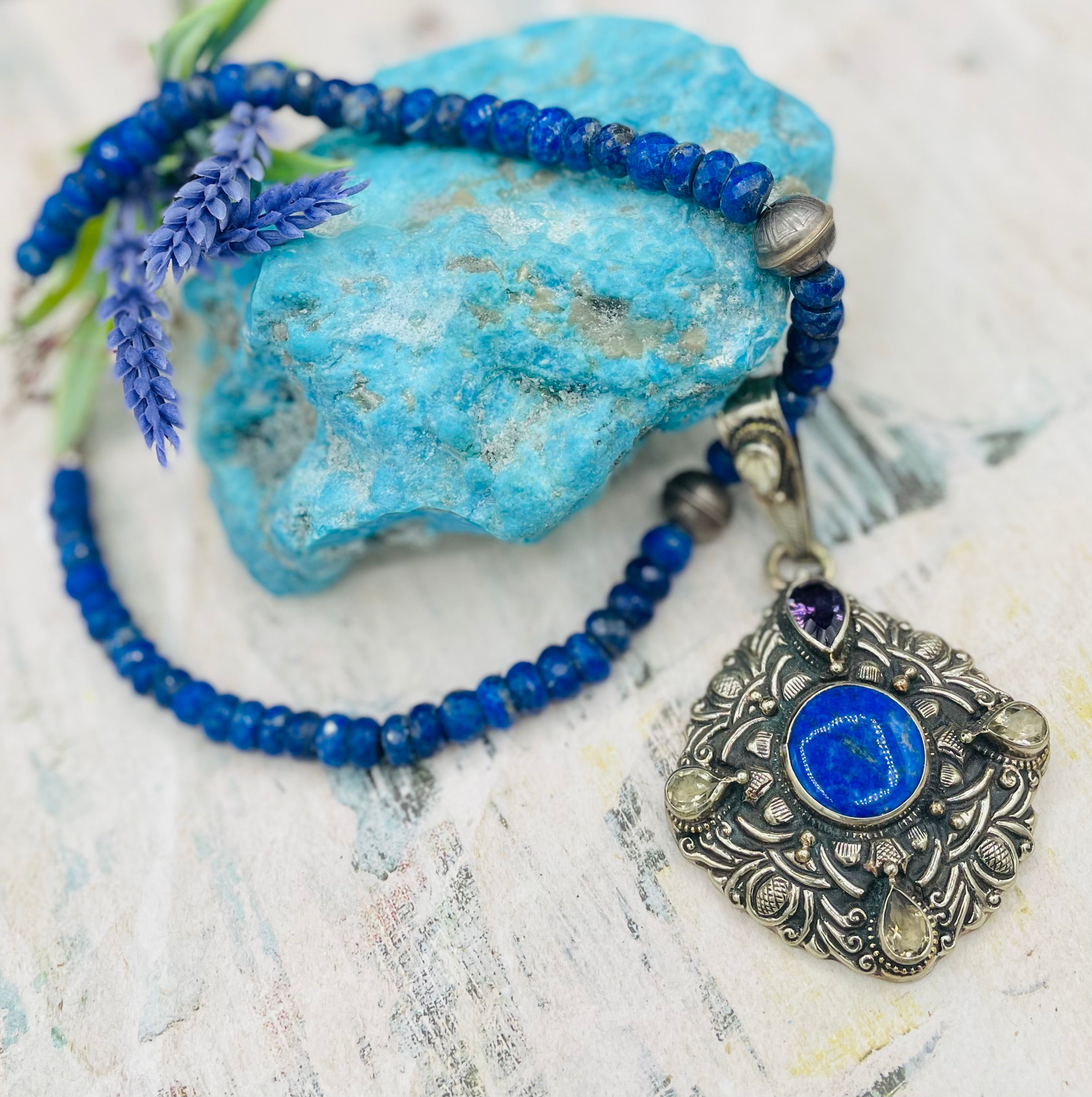 Lapis necklace with stamped sterling silver beads and a Bali silver pendent featuring lapis, lemon quartz, and amethyst. Available only from Rockstar Cowgirl online or in store in  
Cody, Wyoming.  