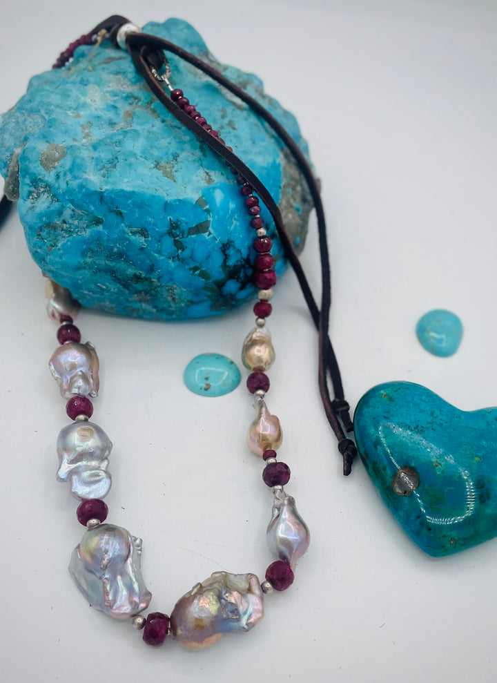 Adjustable beaded hatband featuring flameball natural luster baroque pearls, ruby, sterling silver beads, African silver, and finished with deer lace in the back. Available only from Rockstar Cowgirl online or in store in Cody, Wyoming.