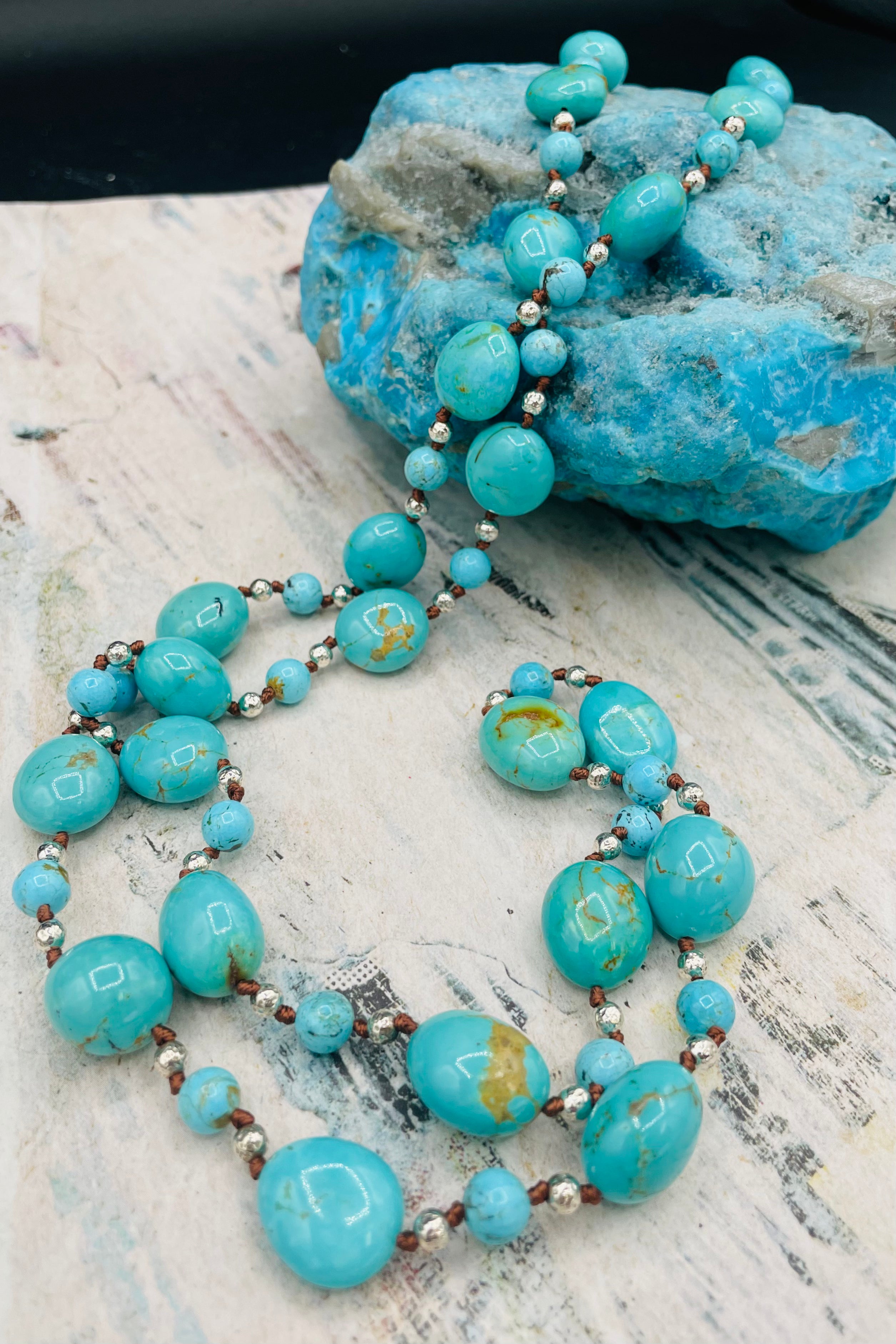 Long silk knotted necklace featuring Kingman turquoise nuggets and rounds with gold matrix, and hammered sterling silver beads. Available only from Rockstar Cowgirl online or in store in Cody, Wyoming.