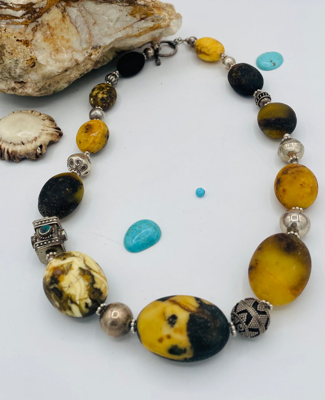 Chunky beaded necklace featuring Baltic amber, repousse beads with turquoise inlay, and sterling silver beads. Available only from Rockstar Cowgirl online or in store in Cody, Wyoming.