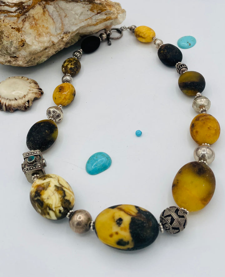 Chunky beaded necklace featuring Baltic amber, repousse beads with turquoise inlay, and sterling silver beads. Available only from Rockstar Cowgirl online or in store in Cody, Wyoming.