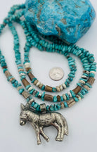 3 strand necklace featuring Campitos turquoise, chrysoprase, and deer antler beads with a donkey pendent. Available only from Rockstar Cowgirl online or in store in Cody, Wyoming.