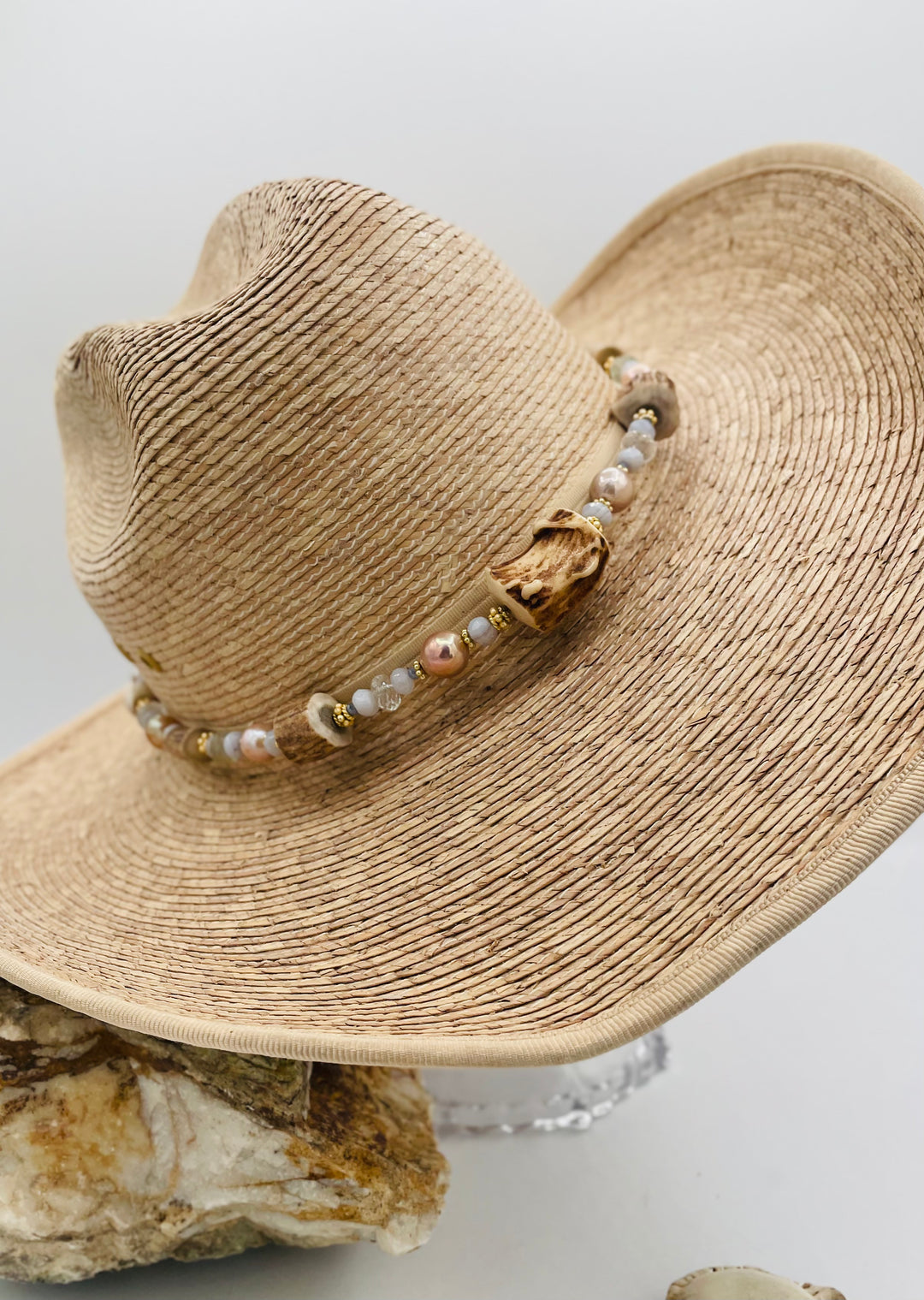 Adjustable beaded hatband featuring blue lace agate, aquamarine, glass crystals, gold details, baroque natural luster pearls, deer antler beads, and finished with deer lace in the back. Available only from Rockstar Cowgirl online or in store in Cody, Wyoming.