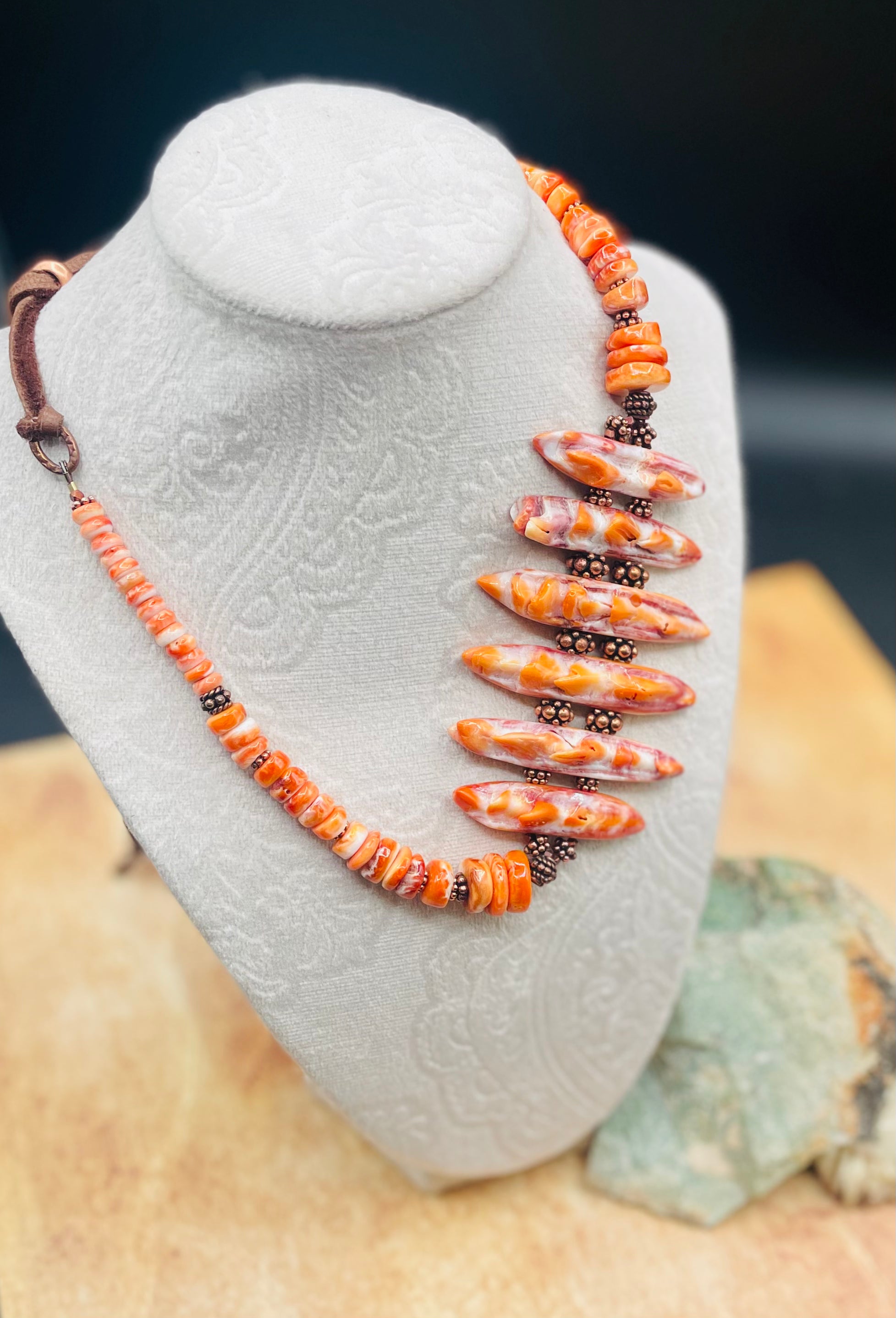 Hatband or necklace featuring several shapes of spiny oyster beads and copper accents. Finished with deer lace each with a charm and a slide bead for fit. Available only from Rockstar Cowgirl online or in store in Cody, Wyoming.