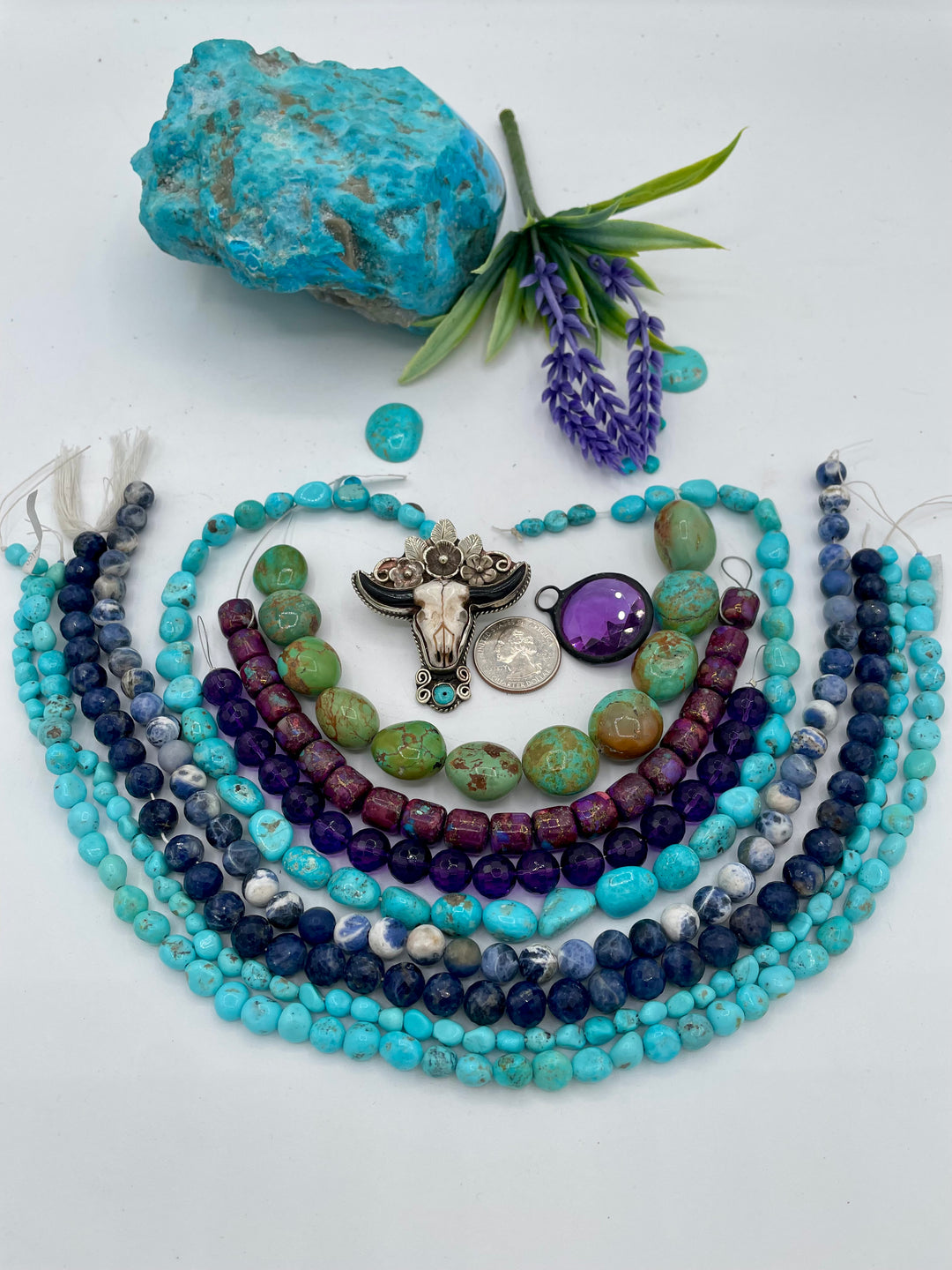 Bead box featuring Sonoran turquoise, sodalite, fruity purple turquoise, green Kingman turquoise nuggets, amethyst, steer pendent and crystal charm. U.S. Quarter for size reference. Available only from Rockstar Cowgirl online or in store in Cody, Wyoming. 