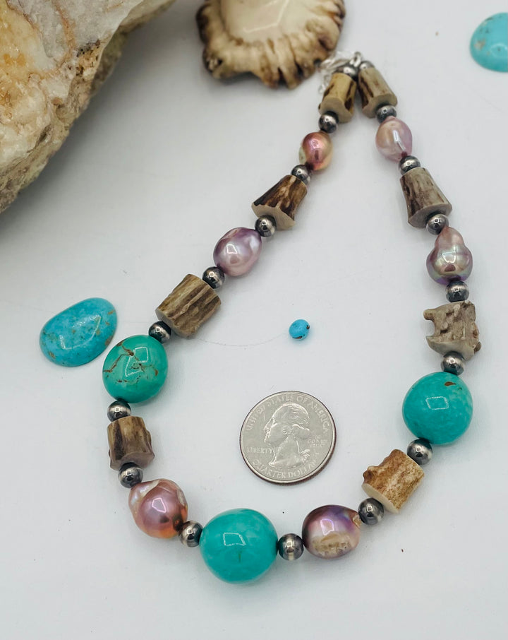 Beaded necklace featuring Kingman turquoise, natural luster pearls, deer antler, and sterling silver beads. U.S. 
quarter for size reference. Available only from Rockstar Cowgirl online or in store in Cody, Wyoming.