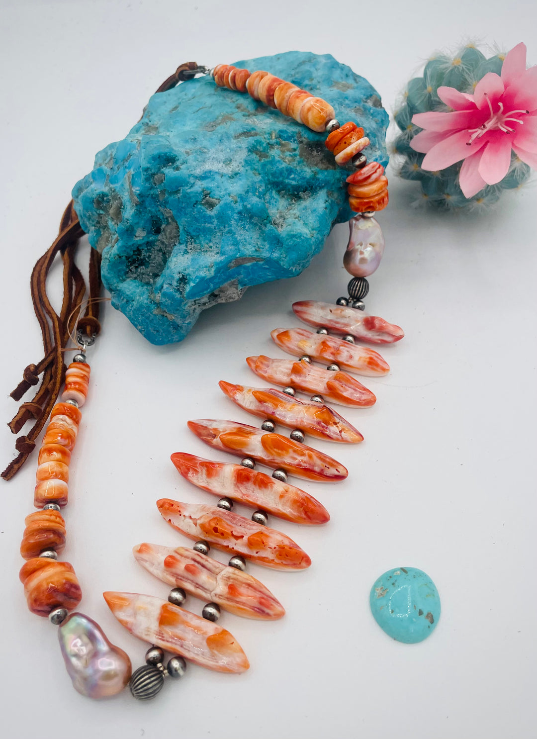 Adjustable beaded hatband featuring spiney oyster, natural luster flameball pearls, sterling silver beads, and finished with deer lace in the back. Available only from Rockstar Cowgirl online or in store in Cody, Wyoming.