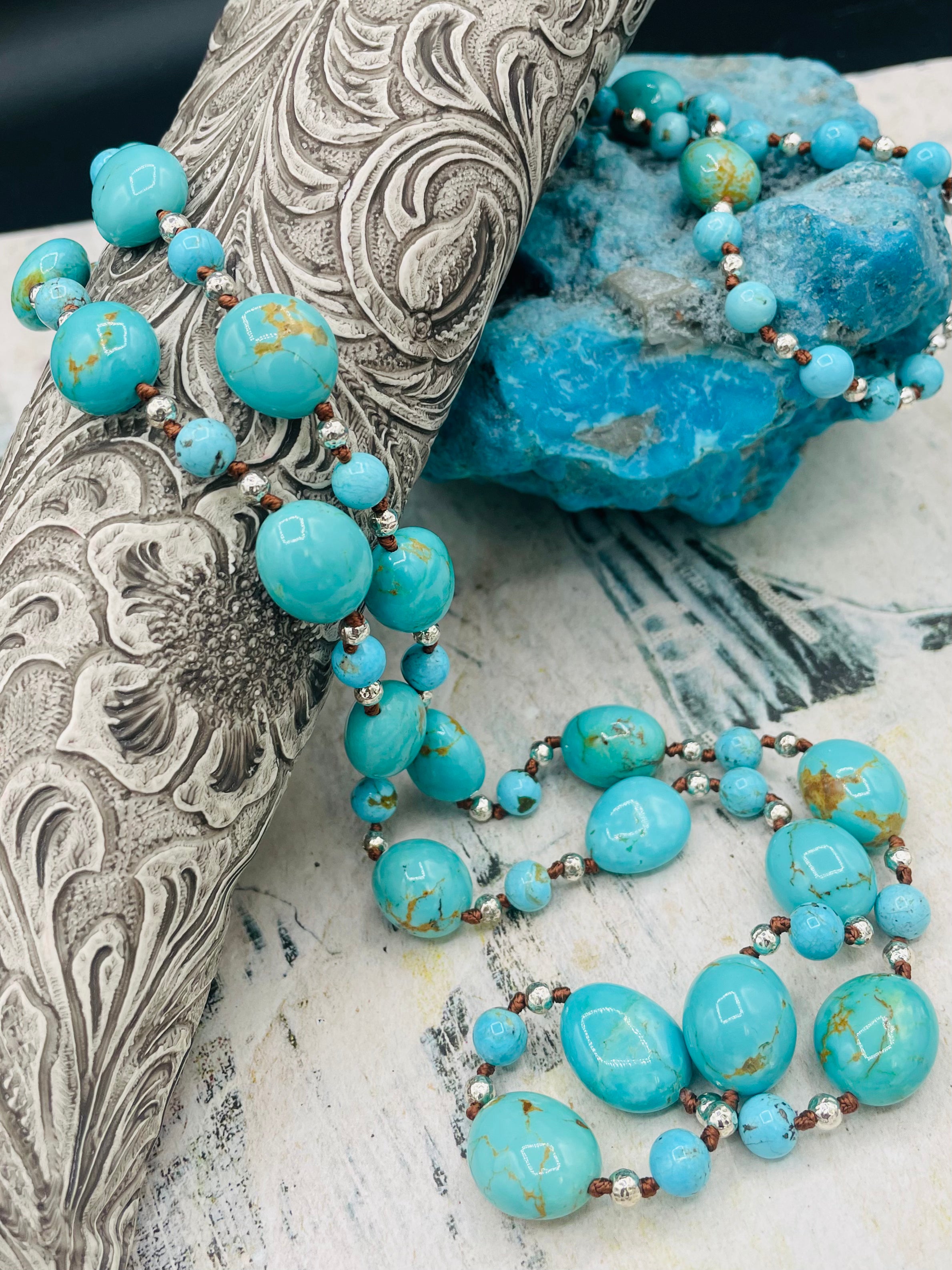 Long silk knotted necklace featuring Kingman turquoise nuggets and rounds with gold matrix, and hammered sterling silver beads. Available only from Rockstar Cowgirl online or in store in Cody, Wyoming.