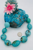 Necklace featuring large Kingman Turquoise nuggets and round beads. U.S. quarter for size reference. Available only from Rockstar Cowgirl online or in store in Cody, Wyoming.