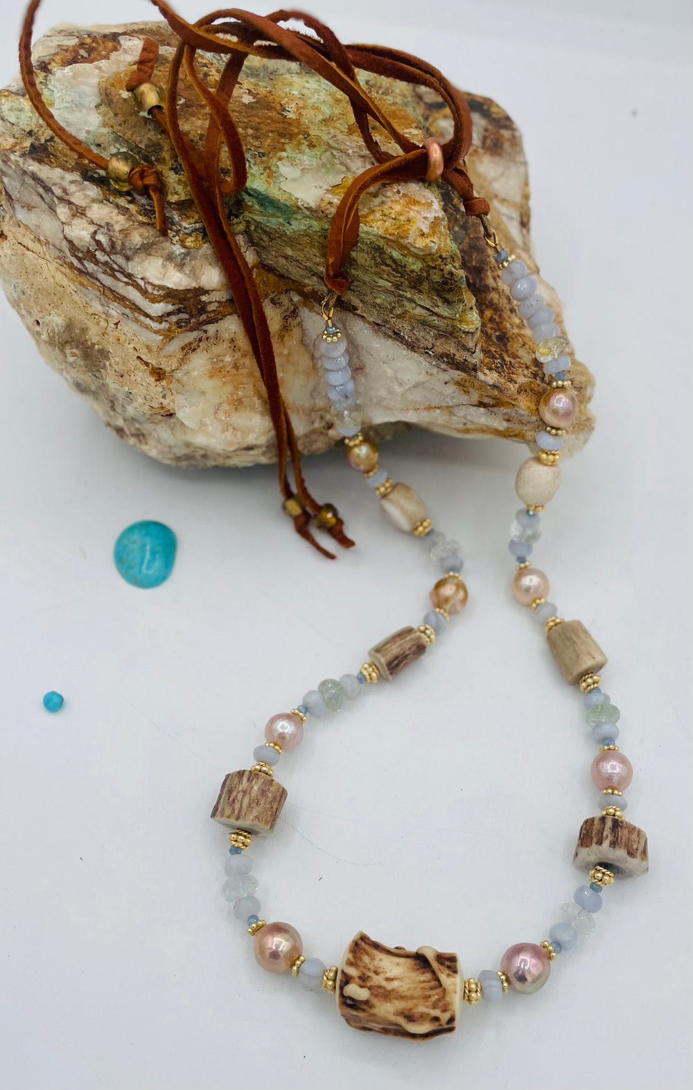 Adjustable beaded hatband featuring blue lace agate, aquamarine, glass crystals, gold details, baroque natural luster pearls, deer antler beads, and finished with deer lace in the back. Available only from Rockstar Cowgirl online or in store in Cody, Wyoming.