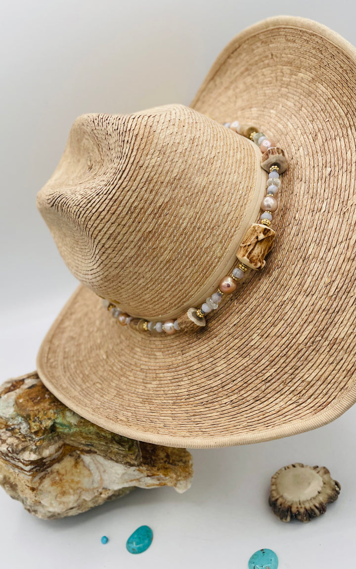 Adjustable beaded hatband featuring blue lace agate, aquamarine, glass crystals, gold details, baroque natural luster pearls, deer antler beads, and finished with deer lace in the back. Available only from Rockstar Cowgirl online or in store in Cody, Wyoming.