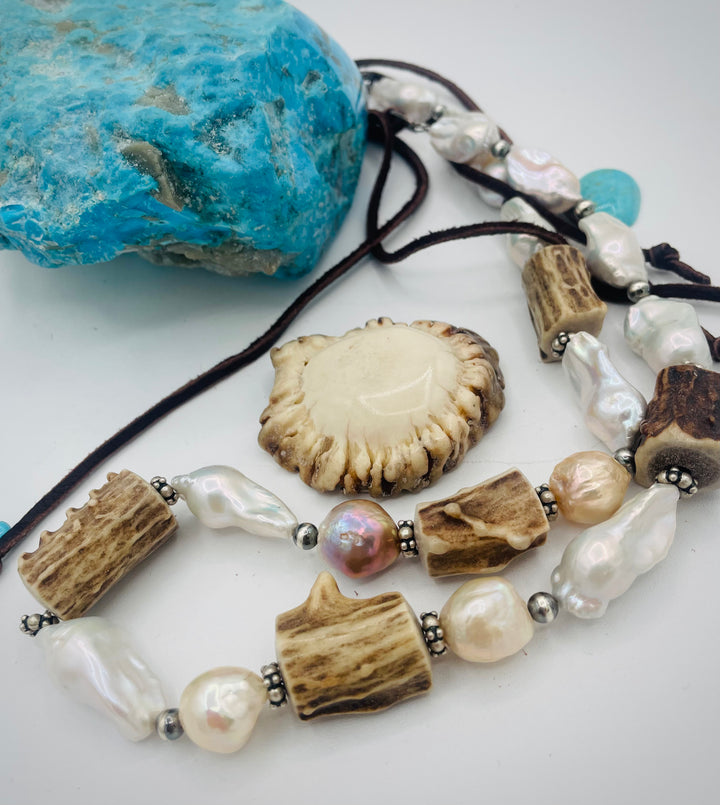 Adjustable beaded hattband featuring white flameball baroque pearls, textured deer antler, sterling silver beads, and finished with deer lace in the back. Available only from Rockstar Cowgirl online or in store in Cody, Wyoming.