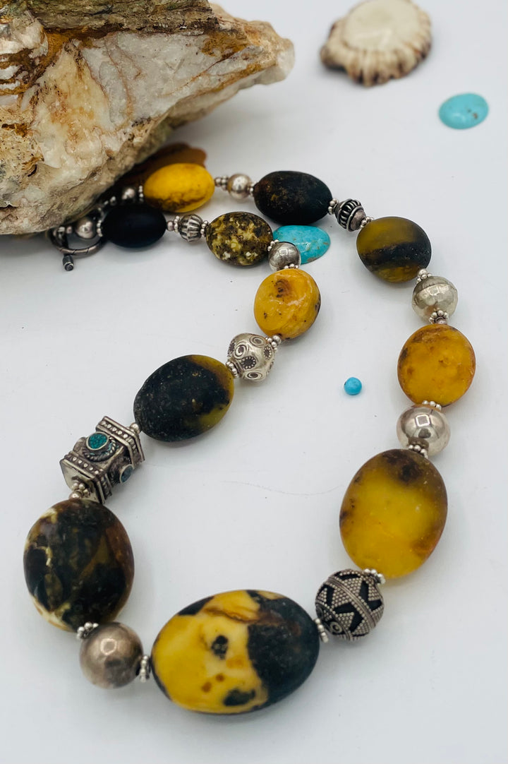 Chunky beaded necklace featuring Baltic amber, repousse beads with turquoise inlay, and sterling silver beads. Available only from Rockstar Cowgirl online or in store in Cody, Wyoming.